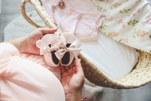woman holding baby shoes trying to find hope again after pregnancy loss