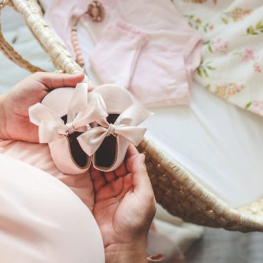 woman holding baby shoes trying to find hope again after pregnancy loss