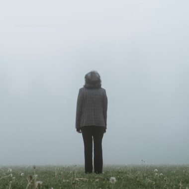 woman standing looking into fog