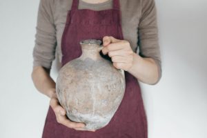 widow holding olive jar who found little is more than enough