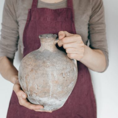 widow holding olive jar who found little is more than enough