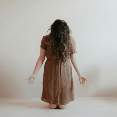 Woman surrendering and praying and if not he is still good