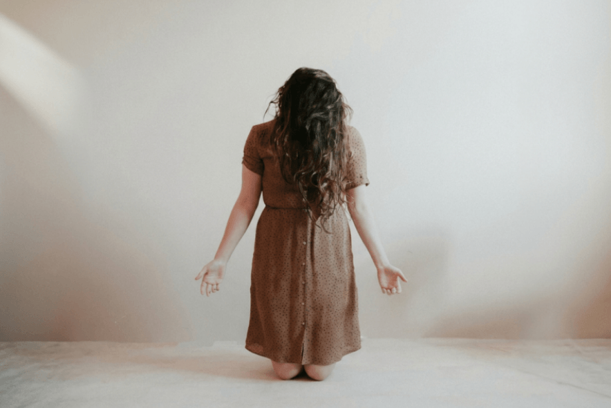 Woman surrendering and praying and if not he is still good