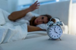 Woman having trouble with sleep. Why loss disrupts sleep and how to help insomnia, night waking, and exhaustion with gentle, practical tips.