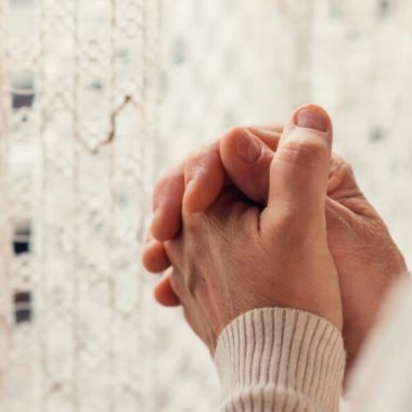 hands folded in grief