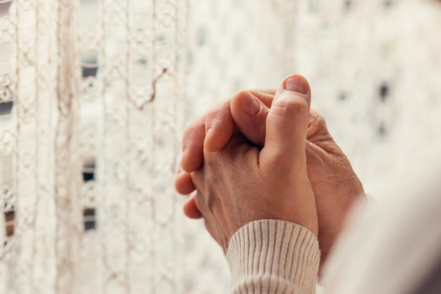 hands folded in grief