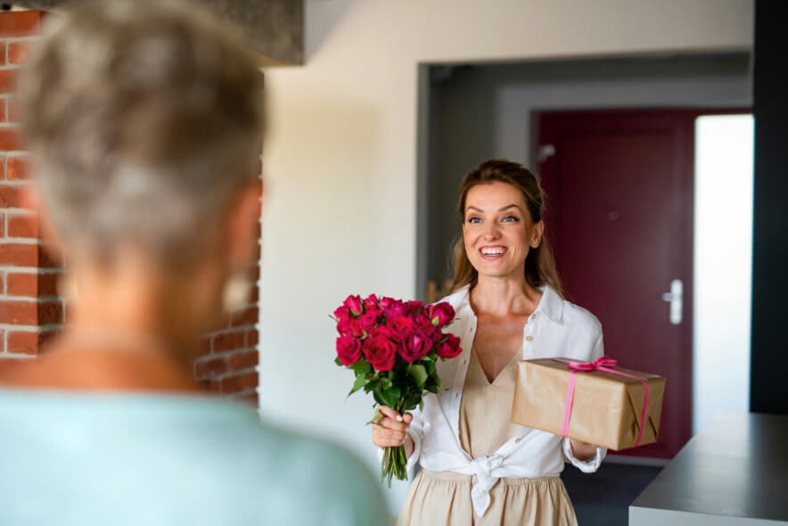 woman bringing flowers and help to grieving woman
